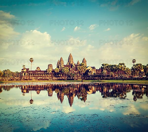 Vintage retro effect filtered hipster style travel image of Cambodia landmark Angkor Wat with reflection in water