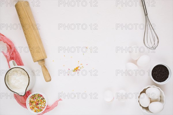 Cooking ingredients near whisk rolling pin