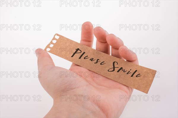 Please smile text on paper on a white background