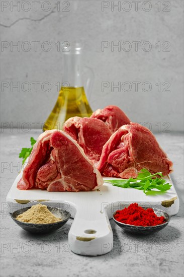 Raw boneless rack of lamb on wooden cutting board