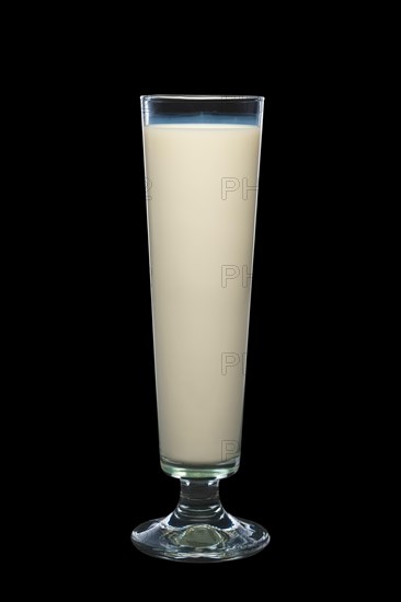 Tall glass of milk isolated on black background