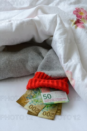 Banknotes in stocking under duvet