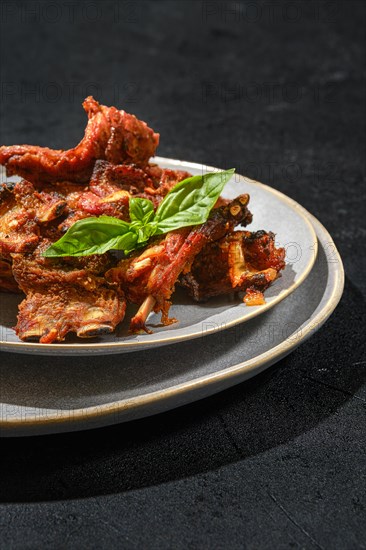 Closeup view of marinated lamb ribs baked in oven