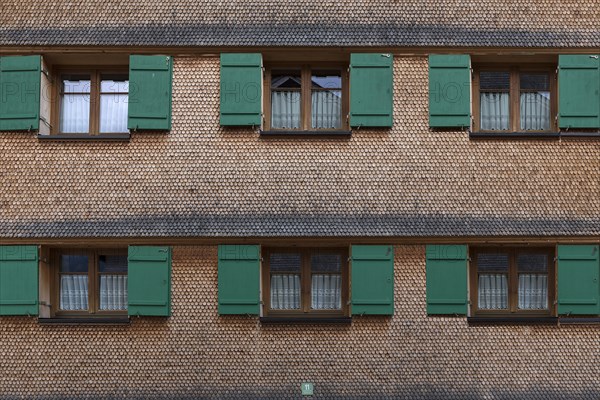 Allgaeu house with shingle facade and shutters