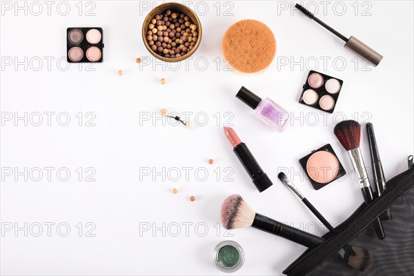 Elevated view makeup brushes cosmetics white backdrop