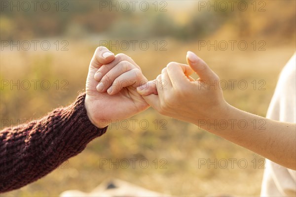 Man woman making pinky promise 1