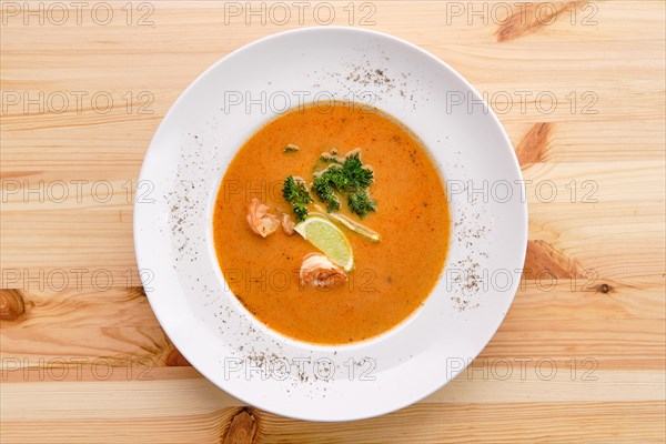 Shrimp soup on wooden table