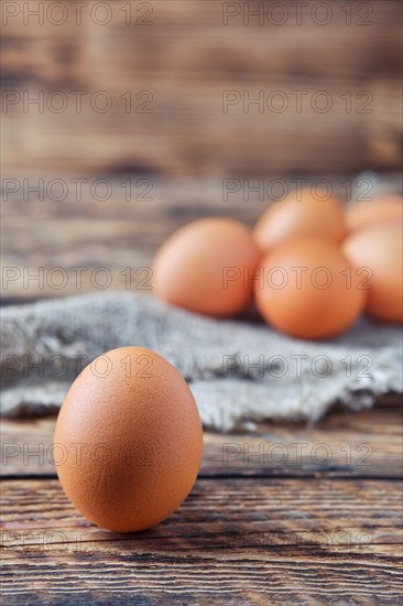 Close up view of brown chicken eggs on wooden table