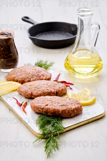 Uncooked cutlet with minced beef meat and cabbage ready for cooking