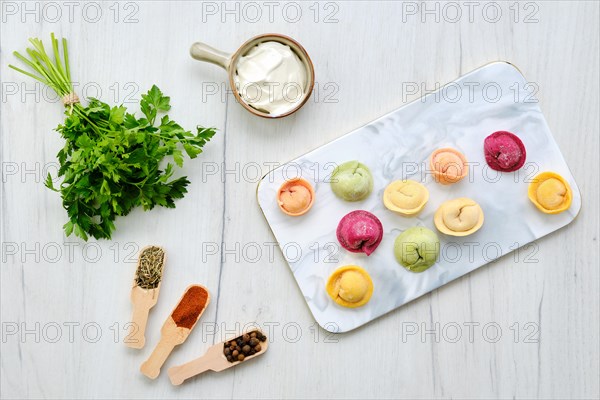 Top view of colorful meat dumplings on marble serving plate