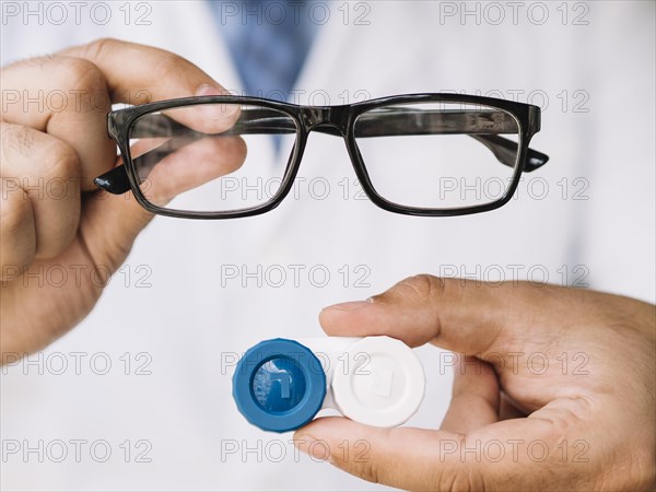Male doctor showing pair black glasses contact lens. Resolution and high quality beautiful photo