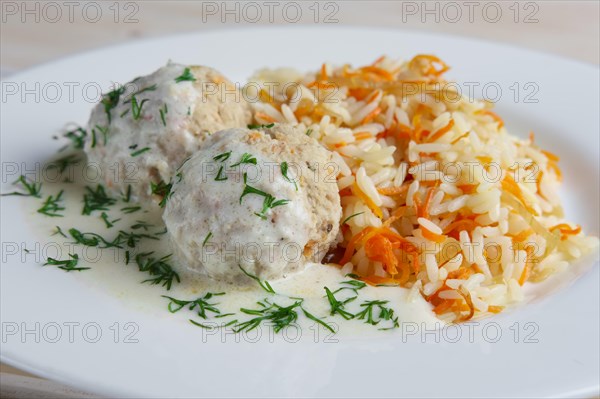 Close-up view of meatballs with rice and carrot