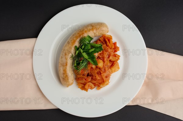 Top view of homemade sausage with stewed cabbage