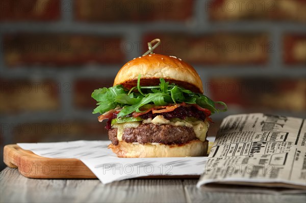 Burger on the wooden table with cheese