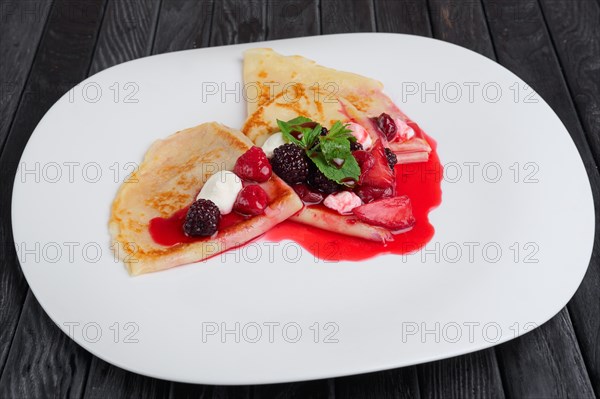 Plate with pancakes decorated with marshmallows