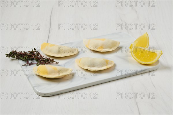 Semifinished frozen salmon dumplings on serving board