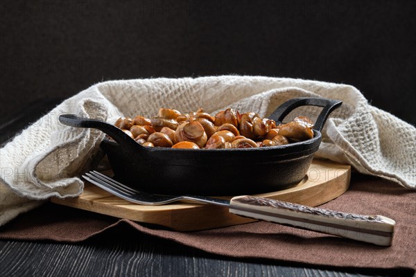 Cast iron pan with fried champignon with spice