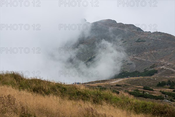 View of the mountain with tourists in the background