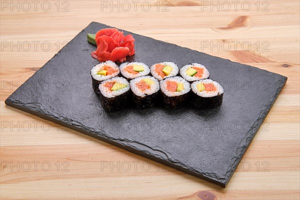 Rolls with salmon and avocado on slate plate