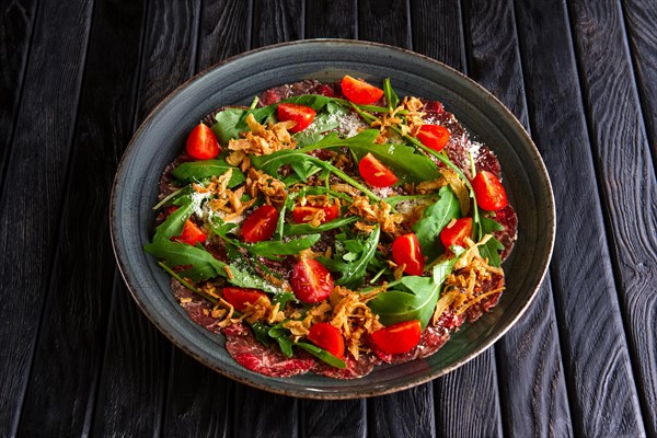 Beef carpaccio with tomato cherry