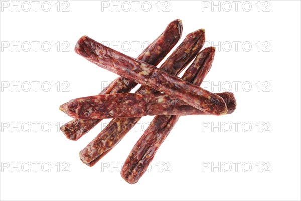 Dried jerked deer and pork sausage isolated on white background