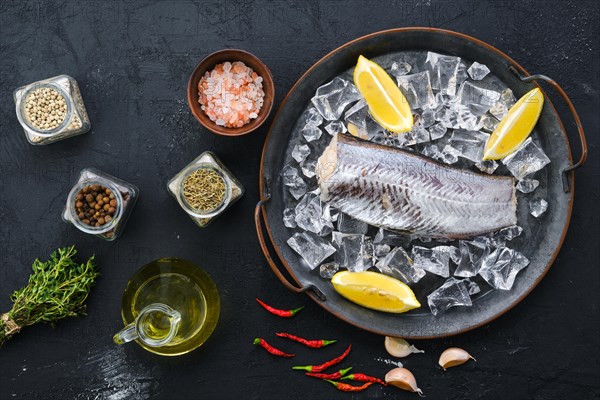 Top view of frozen raw pollock carcass on wooden background