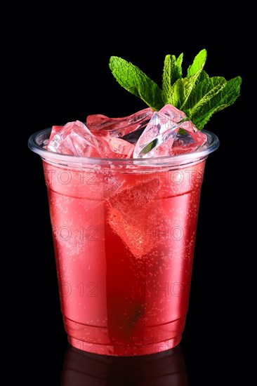 Cold fizz cocktail with strawberry in take away cup isolated on black background