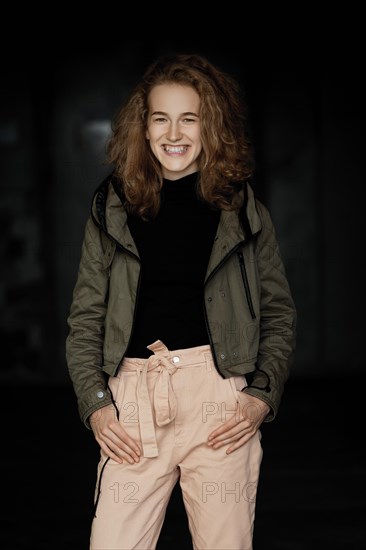 Low key portrait of a student girl in jacket