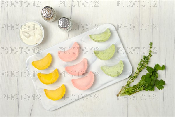 Top view of frozen colorful dumplings with chicken and turkey ground meat