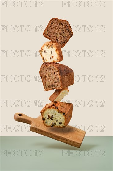 Stacked pieces of biscuit cupcakes. Balancing cakes on wooden board