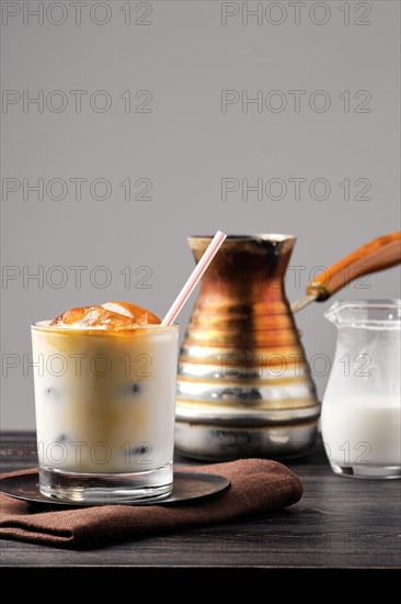 Iced latte with frozen coffee cubes and sweet cream