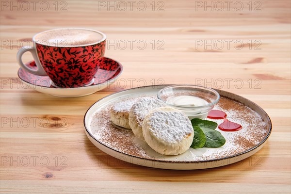 Traditional breakfast with cottage cheese pancake with sour cream