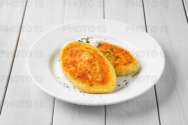 Traditional belarussian potato cakes with sour cream