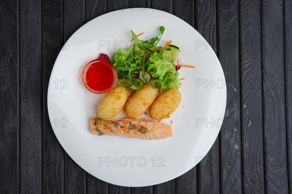 Fried salmon with rice cutlet and spicy sauce