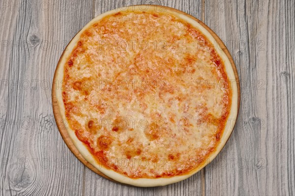 Pizza margherita on wooden table