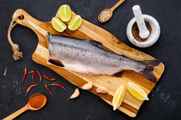 Top view of raw fresh headless pink salmon on wooden cutting board