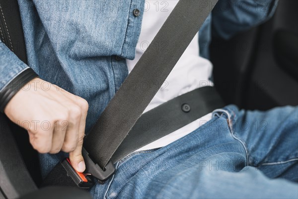 Close up man putting safety belt