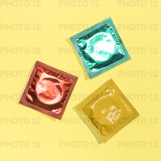 Top view colourful condoms yellow background. Resolution and high quality beautiful photo