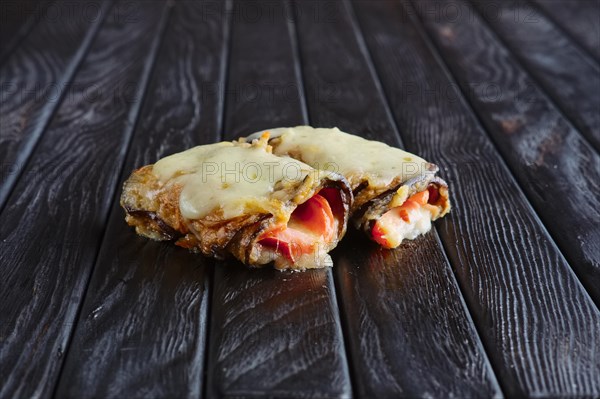 Appetizer for reception. Eggplant stuffed with bacon