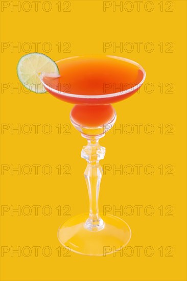 Cosmopolitan cocktail on yellow background