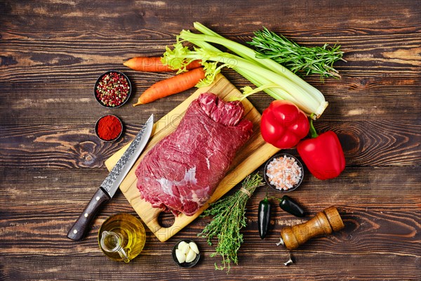 Overhead view of raw beef roll stuffed with vegetables for baking in oven