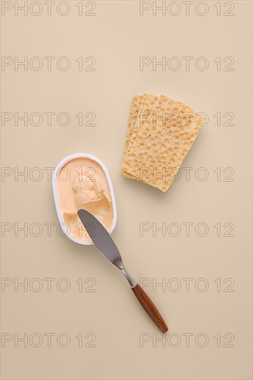 Overhead view of soft cream cheese with dried bread toast