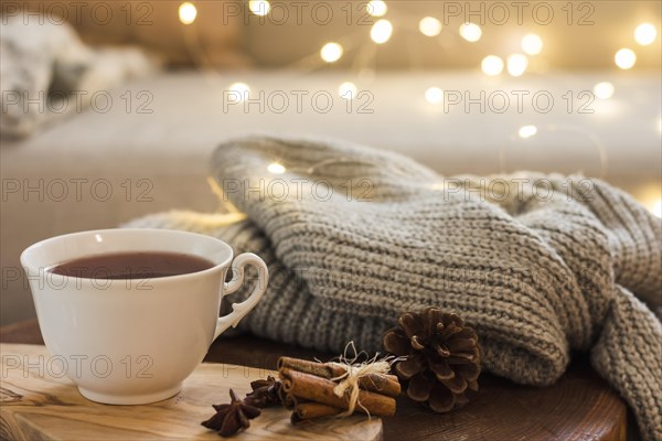 Tea cup wooden pad with knitted plaid. Resolution and high quality beautiful photo