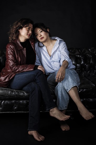 Two Asian woman on couch