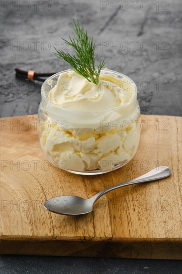 Closeup view of fat sour cream in a glass pot