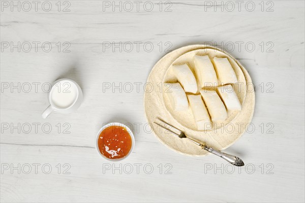 Top view of semifinished frozen lazy dumplings made of curd on a plate