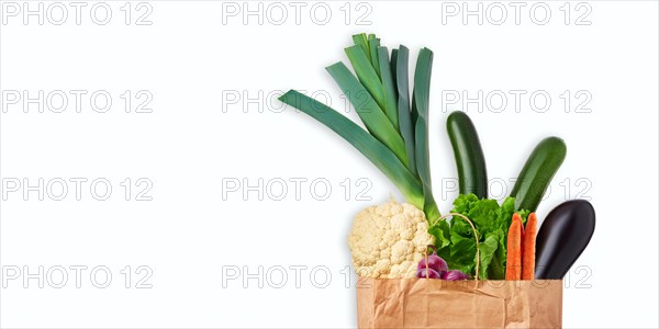 Paper bag with fresh vegetables isolated on white background