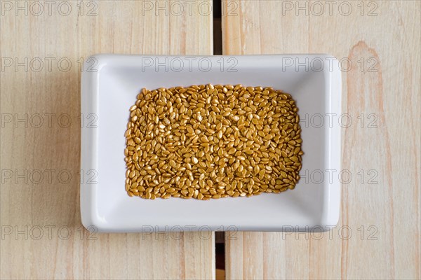 Top view of gold plated sesame seeds in cepamic bowl