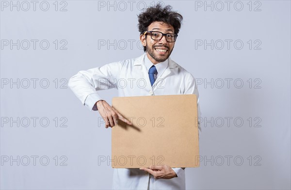 Professor in white coat holding a blank clipboard isolated. A scientist in a white coat is holding a blank clipboard. Scientist showing and pointing at a blank clipboard