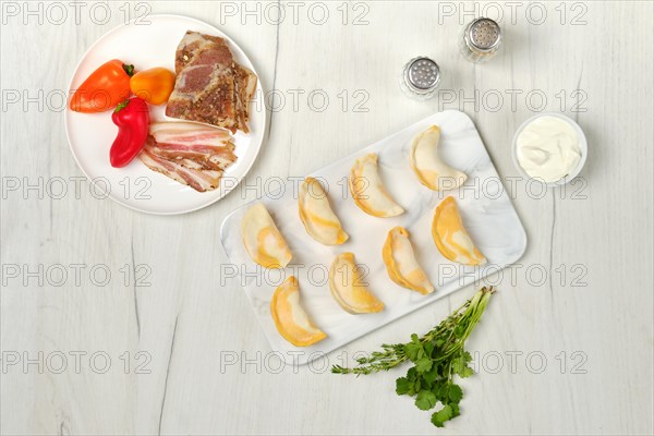 Top view of frozen dumplings with bacon and mashed potato